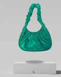 Green handbag on a gray background